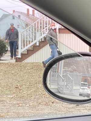 Two men leaving my apartment after the "inspection." One glaring at me and the other maskless.