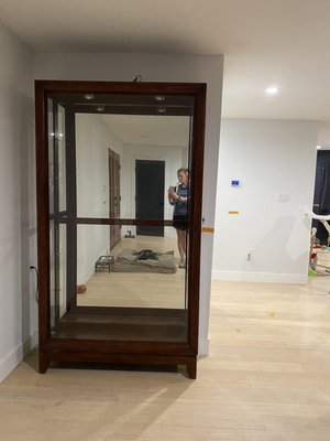 The floor is even, the curio cabinet is even, the wall on the right that they installed is terribly uneven.