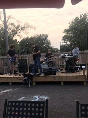 Local band Carjé performing in outdoor seating area