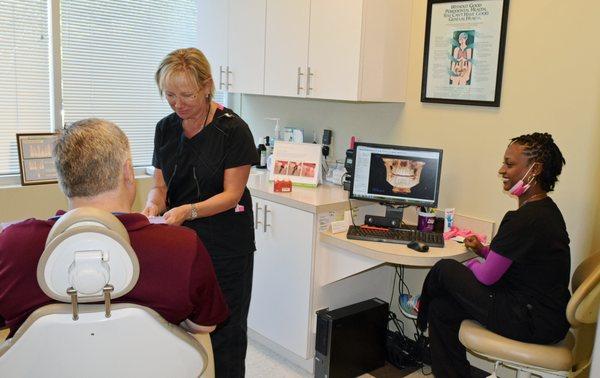 Dr. Susan Baker assisting patient with periodontal info