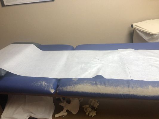 Exam table in desperate need or repair and chairs need cleaned and replaced .