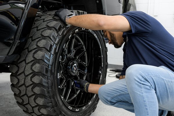 One of Prestige Auto Appearance staff applying rim coating protection.