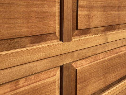 freshly stained cedar garage door, on a cloudy day.