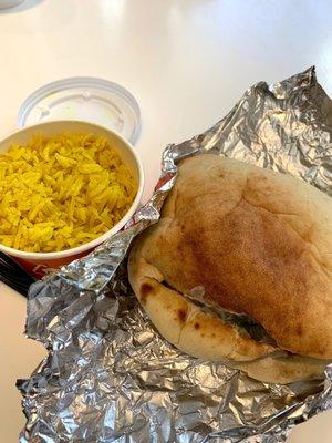 Falafel Pita with hummus, chopped veggies and garlic sauce with some yellow rice.