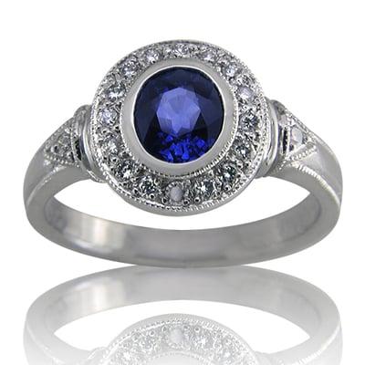 Classic Beauty with a brilliant blue sapphire surrounded by a halo of diamonds.