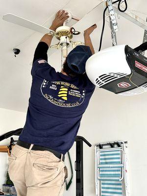 One of our professional electricians installing a new ceiling fan.