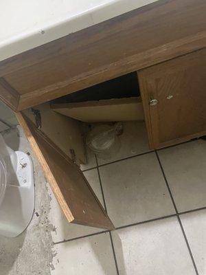 broken cabinet that had spiders inside the pipes