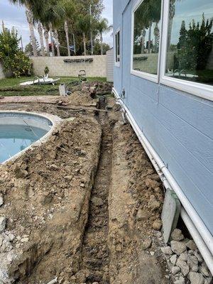 New trenching for existing solar water heater system relocation and replacement of old pool pipes.