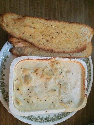 to-go Alfredo tortellini and garlic bread