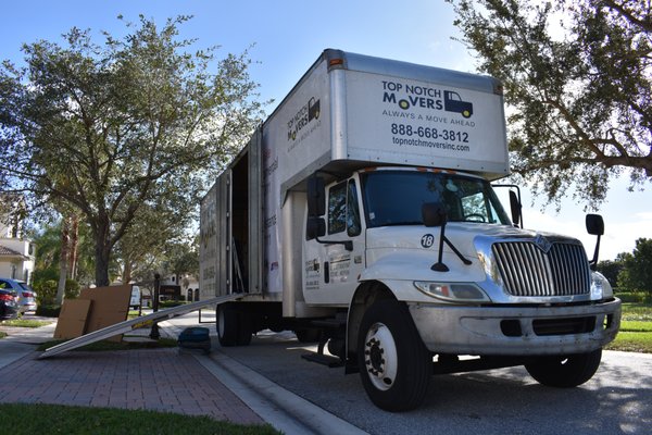 Truck is ready to be loaded. Top Notch Movers parked outside the clients house.