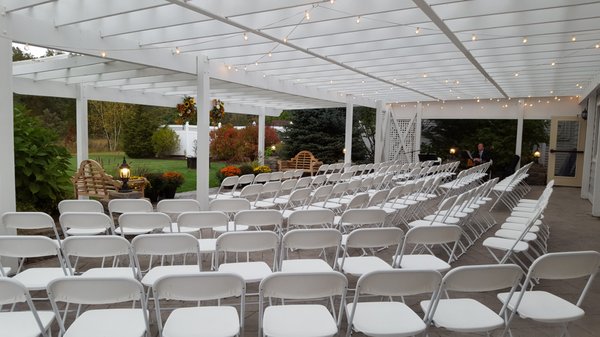 A rain plan option, guests tucked out of the weather on our patio.