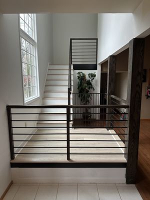 Modern interior railings. Modern stained steps. High end wood columns.