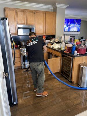 Technician completing water extraction during a emergency service call.