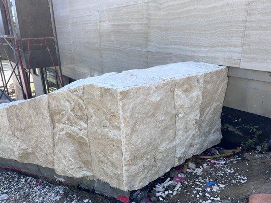 Travertine blocks installed on driveway wall