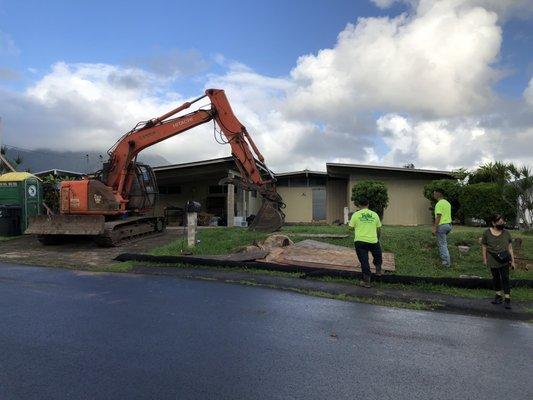 Excavator ready to demolish house.