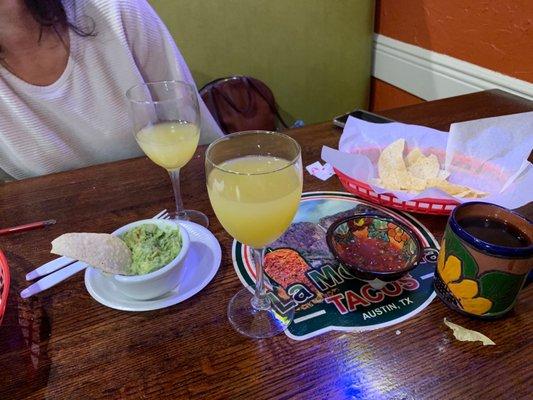 Mimosas and chips with guacamole.