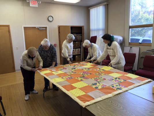 Making quilts out of old bed sheets.