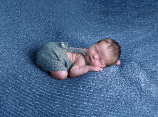 Newborn baby boy on blue