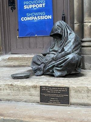 Sculpture of a beggar by Timothy Schmaltz