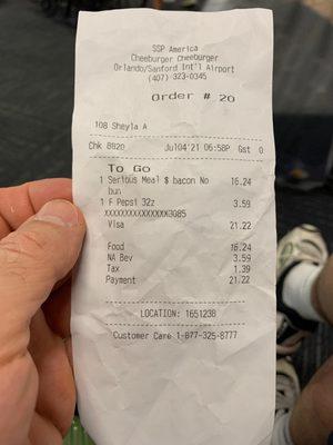 The bill for one bacon burger, fries and a soda.  $21.22