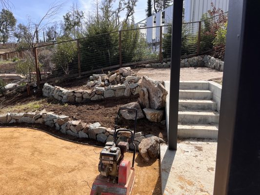 Dry stack walls and patio getting compacted.