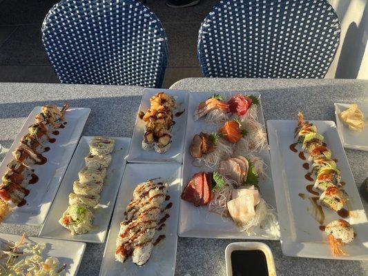 Sashimi platter in the middle, plus a variety of rolls