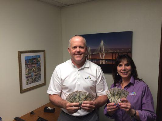 Sam Thompson and Sales Rep, Mindy Popowski holding 10 - $50 bills that were mailed out in the March 2017 Mailer.