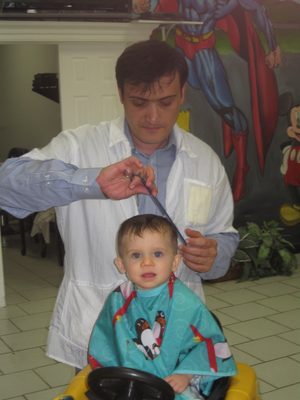 Isak cutting my grandson's first hair cut.