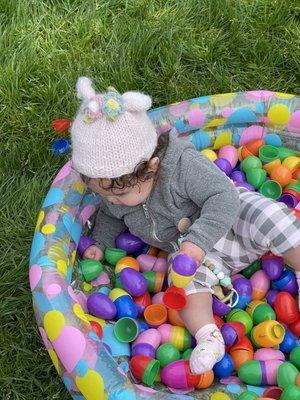 Playing in the Easter egg pool for the under one year olds.