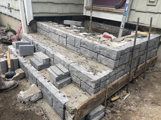 Stone veneer steps we are currently working on. Bluestone treads will be installed, w/ pavers set in cement for the top. More to come