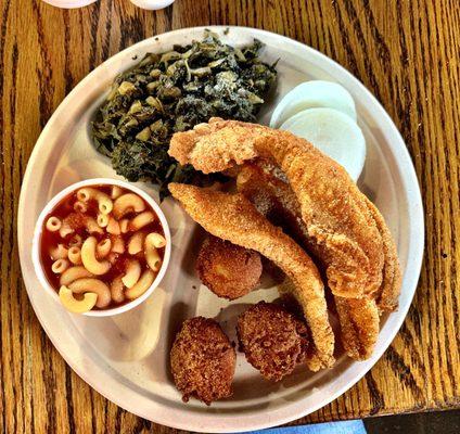 4 piece fish dinner with greens, macaroni and tomatoes and hush puppies. Very good!