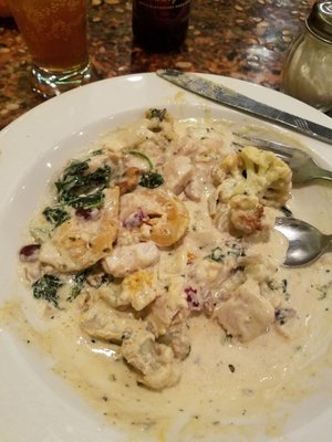 Pumpkin ravioli, with chicken, cauliflower, walnuts, cranberries in a creamy sage sauce.