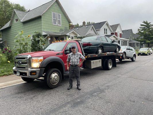 Junk Cars Service tow truck loaded with two junkers in saint paul mn