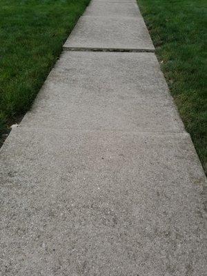 Before picture of this settled and unsafe sidewalk slab