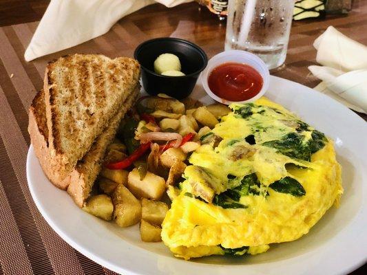 Ultimate omelette with potatoes and toast.