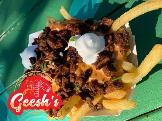 3:10 to Yuma Fries are A basket of fries with Geesh's Refried beans, Queso dip, grilled steak, Pico de Gallo and sour cream.