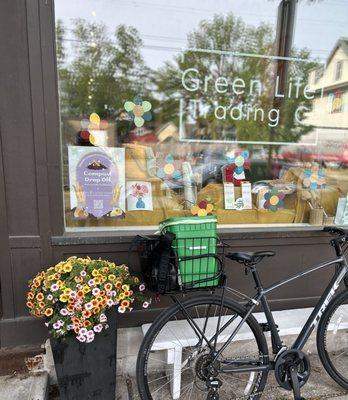 A bike with a Green Box Compost bucket in tow parked outside Green Life Trading Co. on Williamson Street in Madison, Wisconsin.