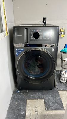 Washer dryer combo I installed with sheet rock and the start of the floor I installed