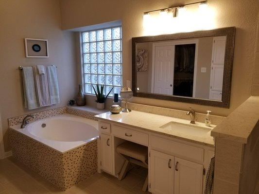 new quartz countertops, painted cabinets with new hardware, new light fixtures and new tile surrounding the tub. Gorgeous!