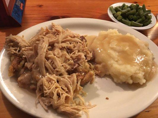 Turkey dinner with potatoes and green beans.