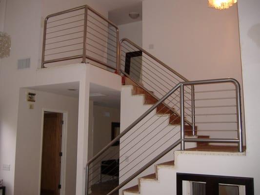 Custom made wrought iron handrail with stainless steel wire.