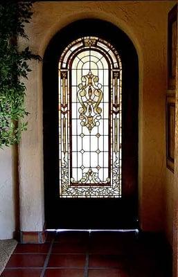 Sliding interior stained glass door in sepia tones