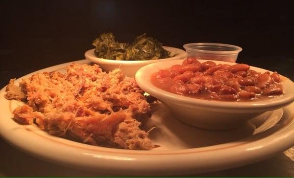 Pulled pork with side of BBQ sauce, fresh turnip greens, pinto beans.