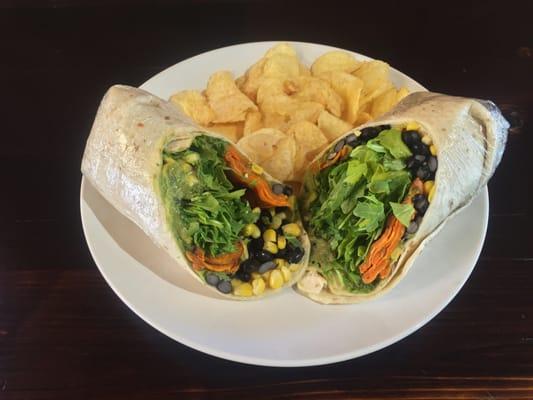 Vegan sweet potato, corn, black bean, avocado and arugula wrap with kettle cooked potato chips.