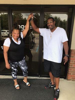 Happy clients just closed on their home. Posing for a picture outside the closing attorney's office.