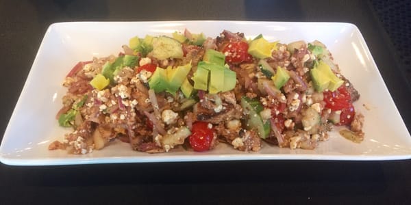 Salad of chicken breast, cucumber, red onion, grape tomatoes, blue cheese, bacon and red wine vinaigrette.