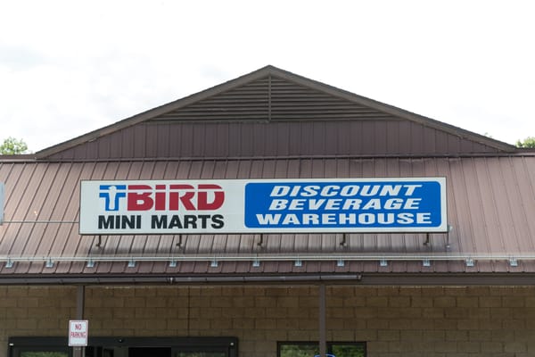 Exterior photo of convenience store and discount beverage warehouse.