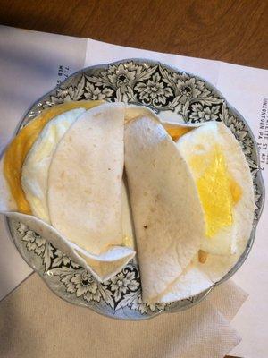 How hard is it to put an egg in a tortilla?? And the eggs were still half frozen that's why they r on a plate to go in the microwave...