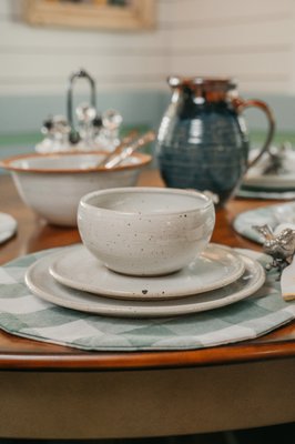 Handmade pottery dishes / tableware set including a dinner plate, salad plate and bowl. Large pitcher and scripture bowl in background.