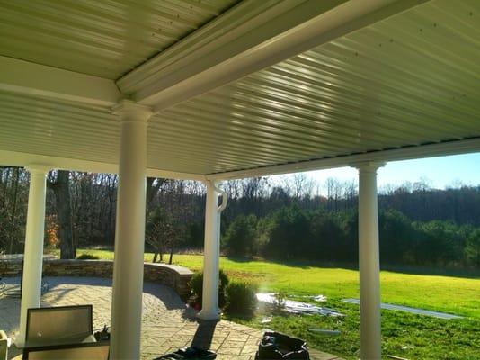 Metal panels and gutters installed under a deck to create a dry space.